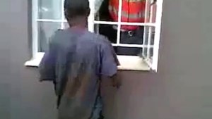 A man enter a house through a narrow protective window-  pulse tv uncut