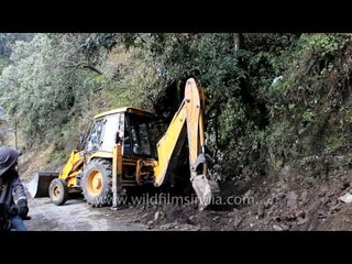 Construction vehicle JCB backhoe digging soil, India