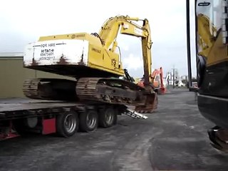How not to unload an excavator.