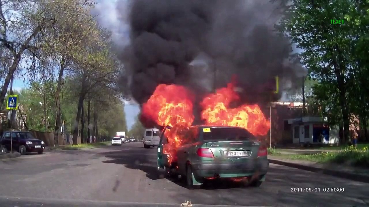 Woman smokes in the car with a bottle of gas