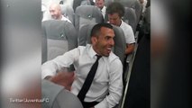 Carlos Tevez celebrates with teammates on Juventus' flight home