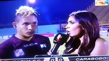 Watch a Venezuelan footballer get kicked in the back while giving TV interview i