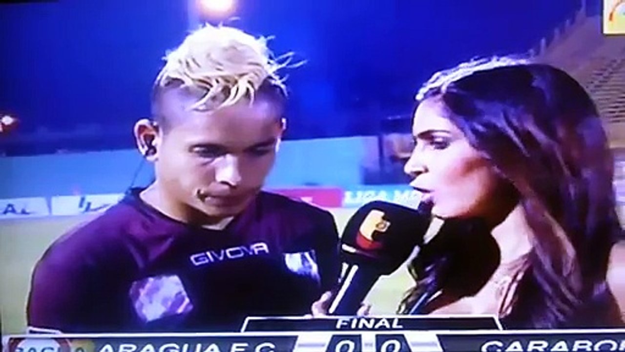 Venezuelan footballer kicked by rival fan during live interview