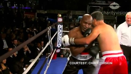 Romney, Holyfield box for charity