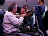 Crazy indian man goes nuts on a plane -funnyvideo2u.flv