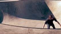 Shot of young skater rolling around in a skatepark.