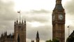 Tight shot of Big Ben and Westminster palace with storm clouds in background in London, England.