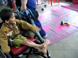 11 year-old boy with cerebral palsy receiving his first wheelchair in India.