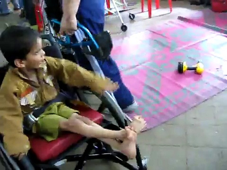 11 year-old boy with cerebral palsy receiving his first wheelchair in India.