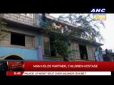Man holds partner, children hostage