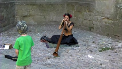 Beauty playing didgeridoo in Carcassonne France
