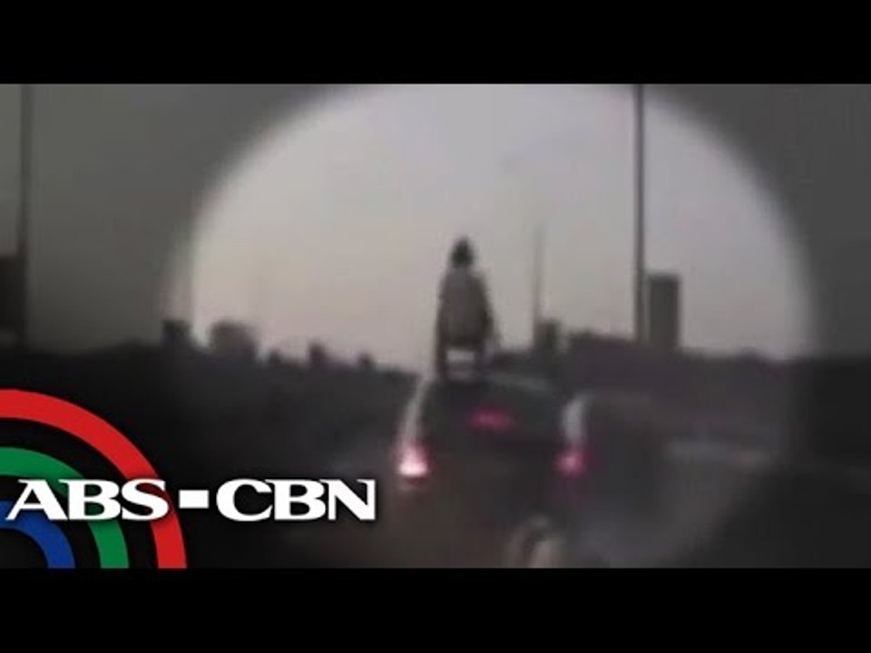 Motorbike rider crashes, lands on top of car