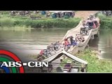 Isabela residents cross damaged bridge