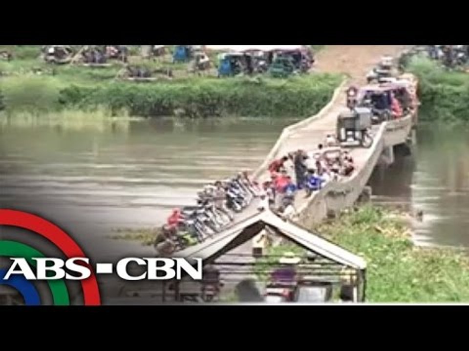 Isabela residents cross damaged bridge