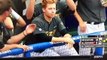 Baseball players warm hands on teammate's fiery red hair