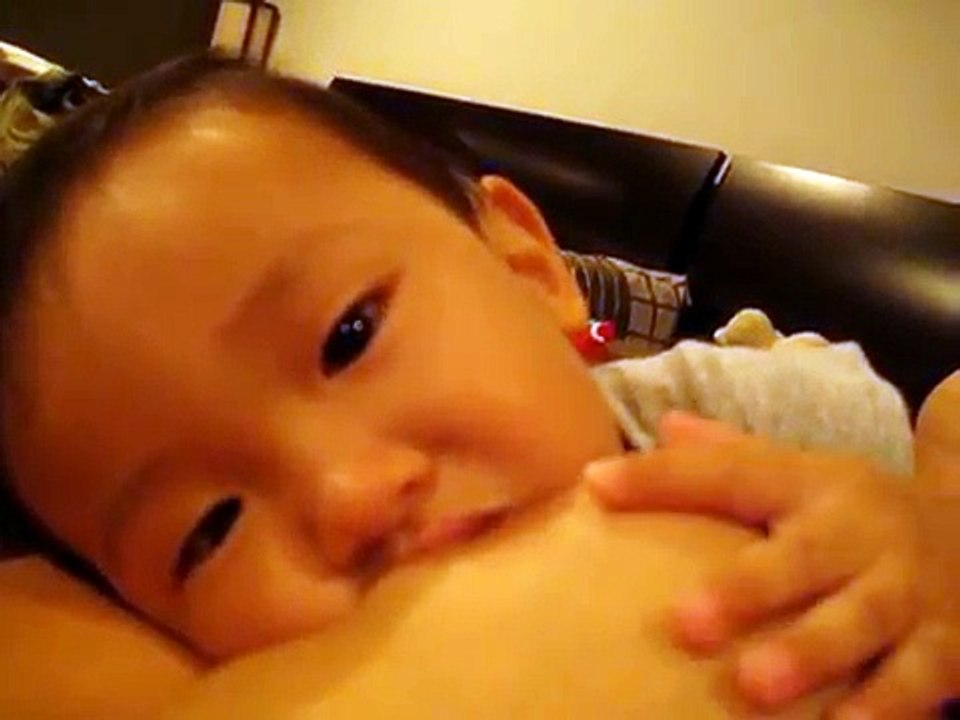 Laughing breastfeeding baby