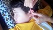 Japanese mom cleans son's ears with a stick!