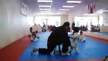 Little Boy Trying To Break Board In Taekwondoo