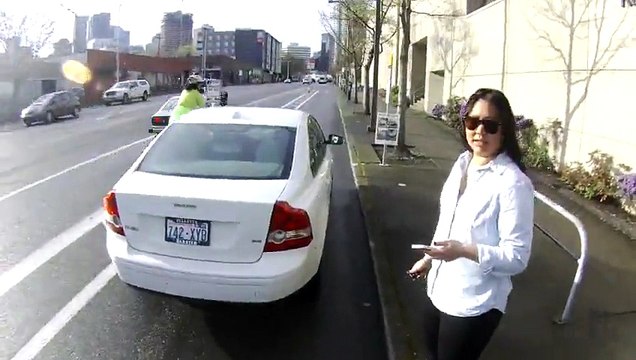 Dumb driver parks in bike lane and insults bikers... Bad girl!