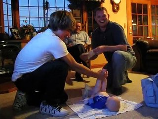 Teenage boy changing diaper