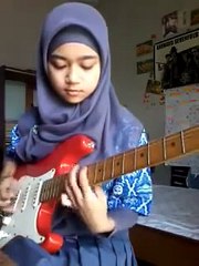 Cool: Muslim girl expertly playing electric guitar