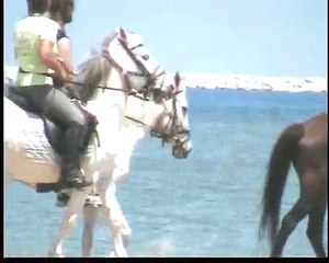Horse Riding on the beach in Naxos, Greece.