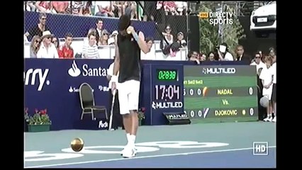 Novak Djokovic mimicing Rafael Nadal in front of him