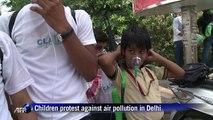 Children wear oxygen masks to highlight air pollution in Delhi