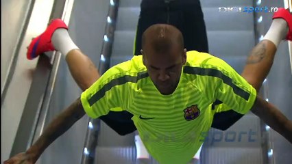 Dani Alves invents a new way to ride the escalator on the way out to Barcelona training