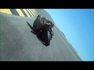 Biker draggin his helmet while cornering