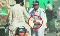 Traffic police in action against helmet rule violators