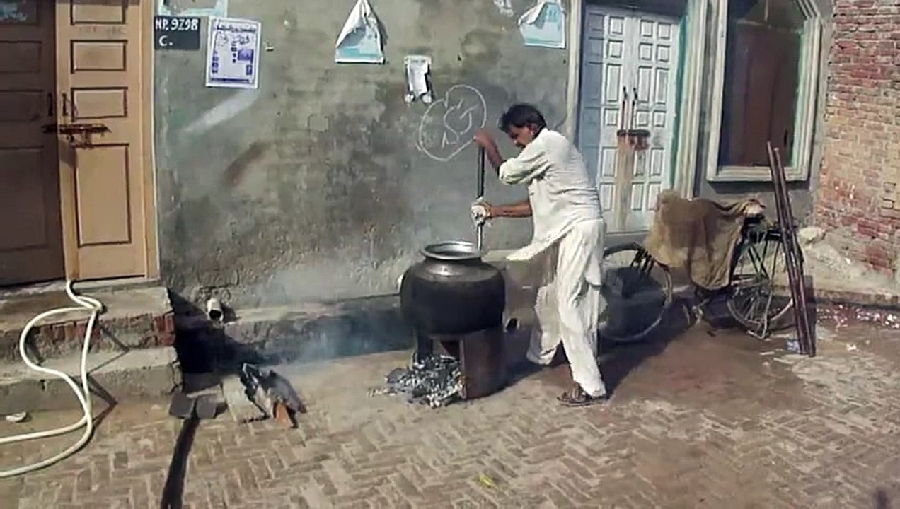 Chief making Rice in Front of Home & Church for Flood Victims..