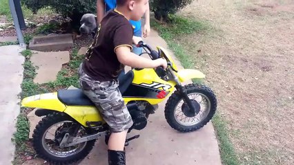 The boy learns to ride a motorcycle