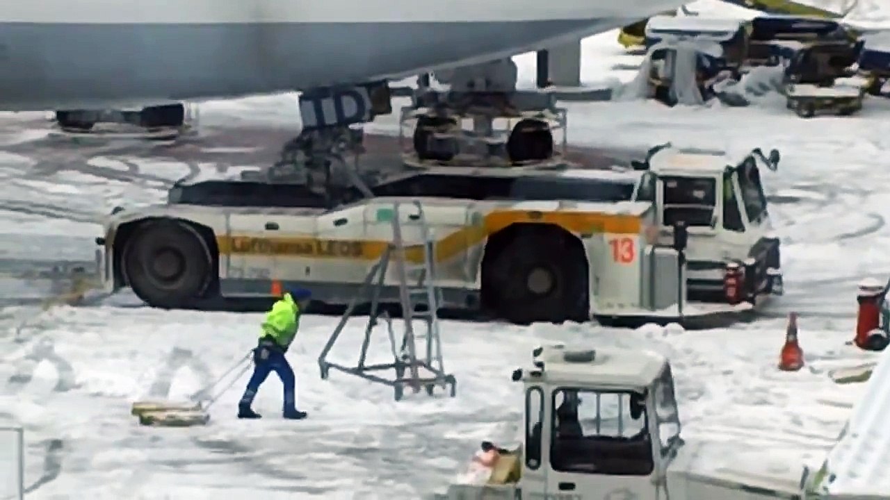 Truck Spins Tires Trying to Tow Lufthansa Plane December 2010 European Snow Storm HD