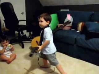 2 year old playing Bulls on Parade on Guitar Hero.....the music takes over.
