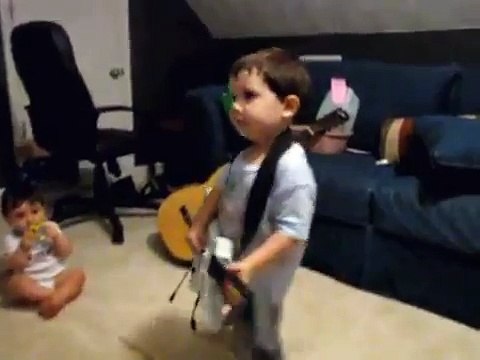 2 year old playing Bulls on Parade on Guitar Hero.....the music takes over.