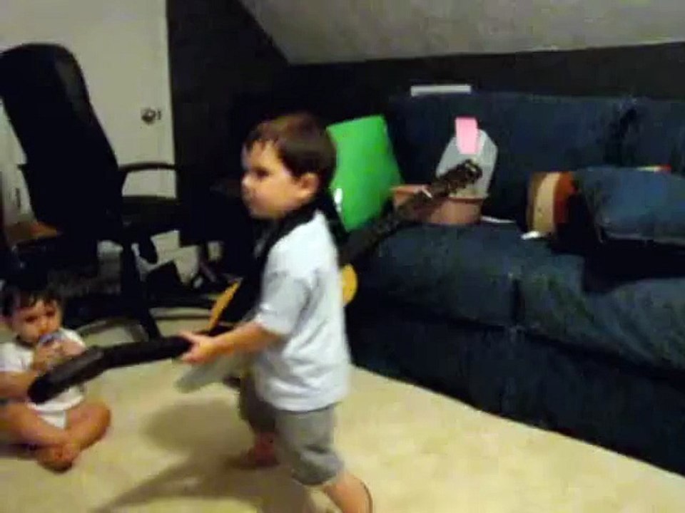 2 year old playing Bulls on Parade on Guitar Hero.....the music takes over.