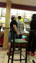 A violent fight to Subway, a man passes through the glass