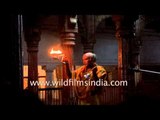 Hindu priest performs aarti at a temple in Varanasi