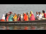 Indian devotees take boat ride on the holy Ganges River - Varanasi