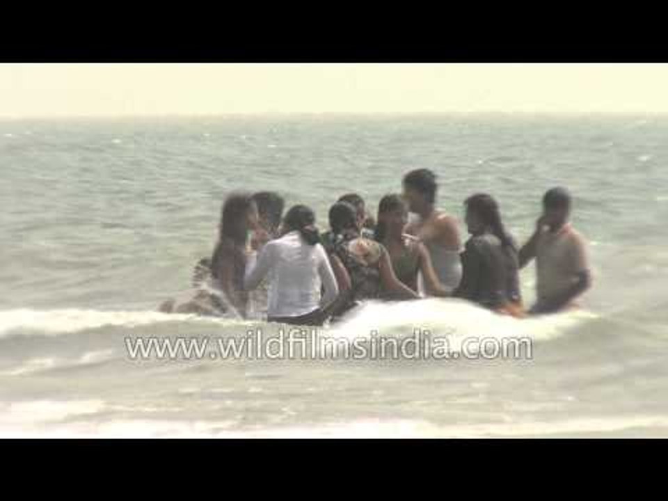 Visitors frolicking at a beach in India