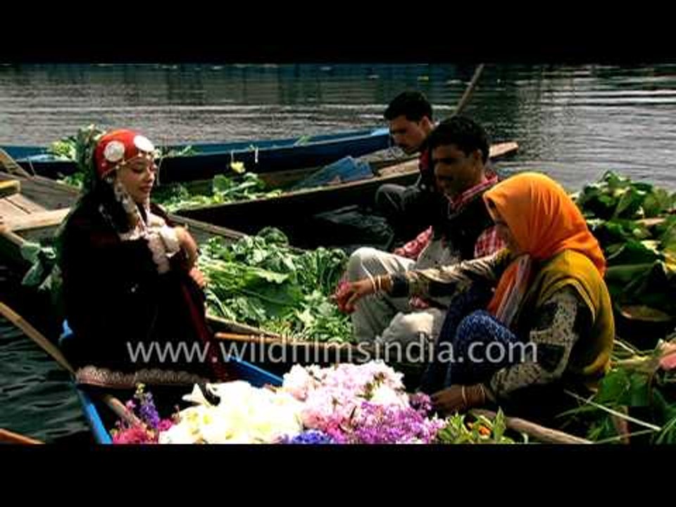 Beautiful Kashmiri girls sell fresh flowers and vegetables on boats