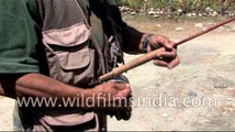 Angler sets up a fishing rod, reel and fly for fishing - Kashmir