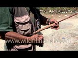 Angler sets up a fishing rod, reel and fly for fishing - Kashmir
