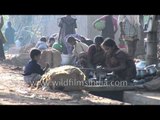Girls wash dishes in Shravanabelagola village, India