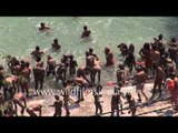 Mass dipping and bathing in the Ganges, by Hindu godmen