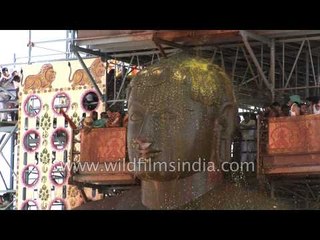 The statue of Bahubali being anointed with turmeric paste in Karnataka