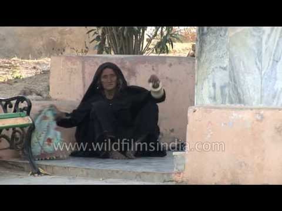Old Vagadia Rabari woman prays at Shri Koteshwar Mahadev Temple in Kutch, Gujarat