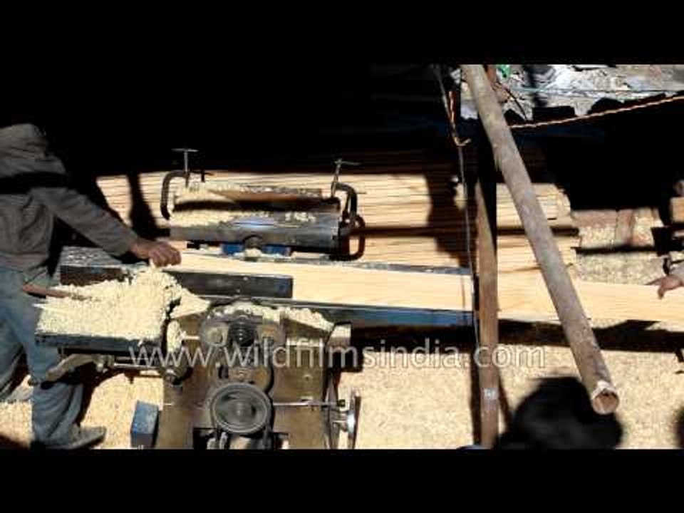 Carpenters prepare pine planks to build Himalayan home