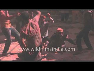 People dance and play with colours during Holi - Vrindavan